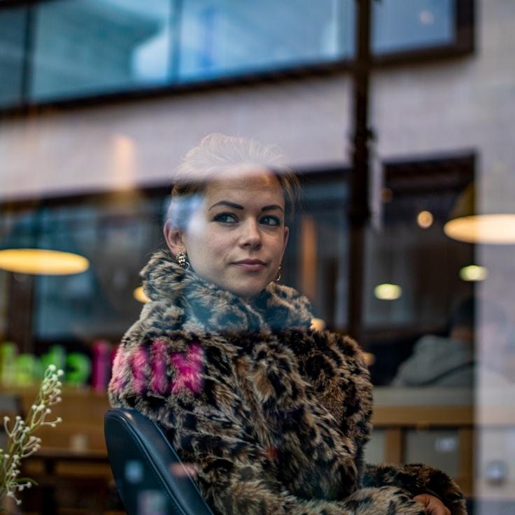 Asha Rao, Lead Design Curator at Harbor Field Leaf, reviewing corporate floral arrangements